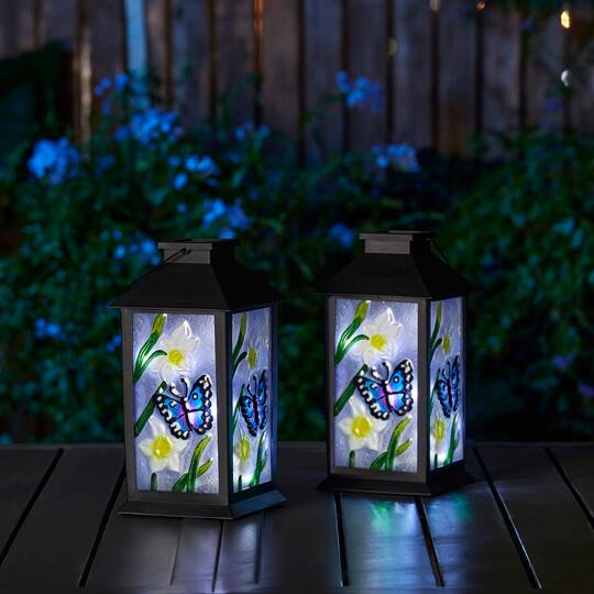Glitzhome® 11" Glass with Butterfly & Flower Pattern Solar Powered Hanging Lanterns, 2ct.